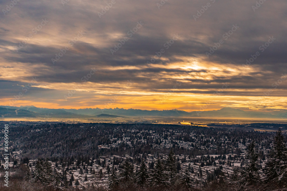 Sunrise over Fraser Valley onb a Winter day with mountains in silhouette