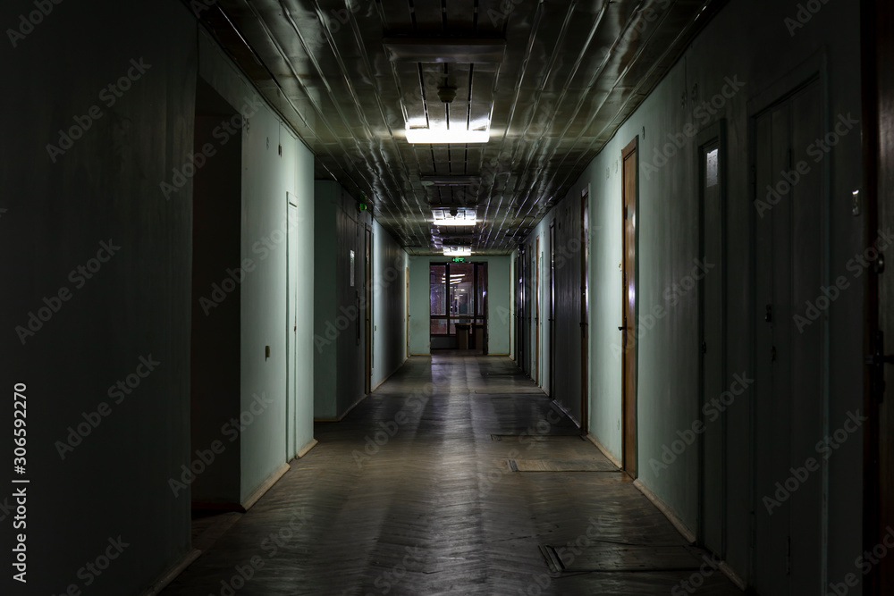 Long dark corridor in an old industrial building Long dark corridor in an old industrial building