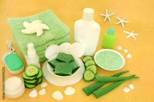 Aloe vera & cucumber natural vegan skin care beauty treatment with cosmetic products on yellow & decorative seashells. Is also an after sun for sunburn. Flat lay, top view.