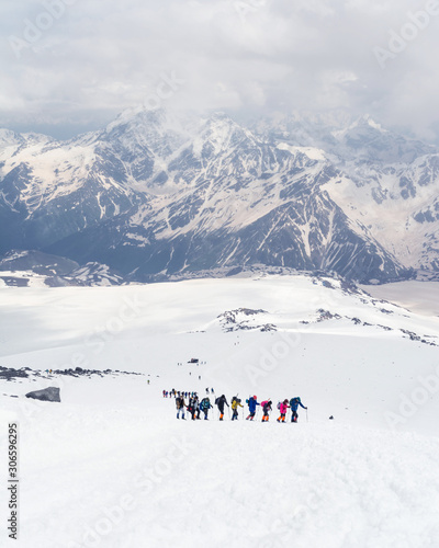 Group of mountaineers climbing in the snowy mountain peaks