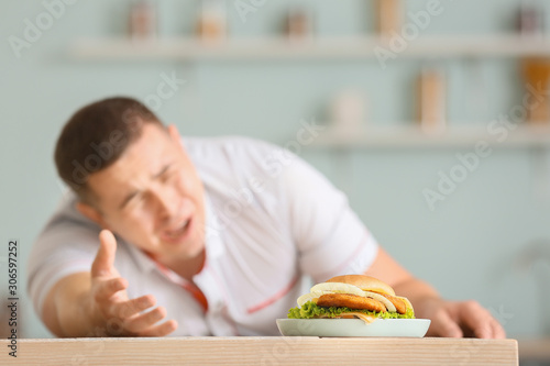 Overweight man stretching h...