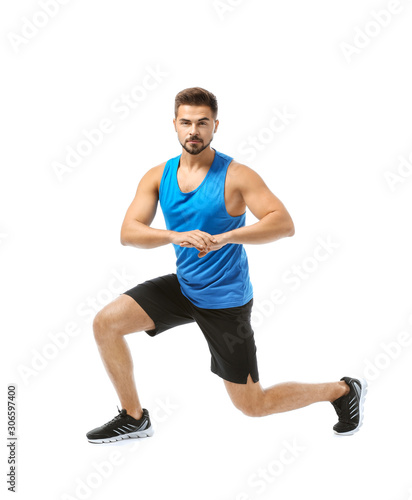Sporty young man training against white background