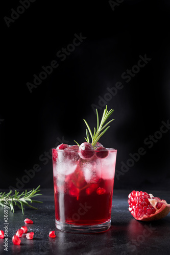Quadro su tela Pomegranate Christmas cocktail with rosemary, champagne, club soda on grey concrete table