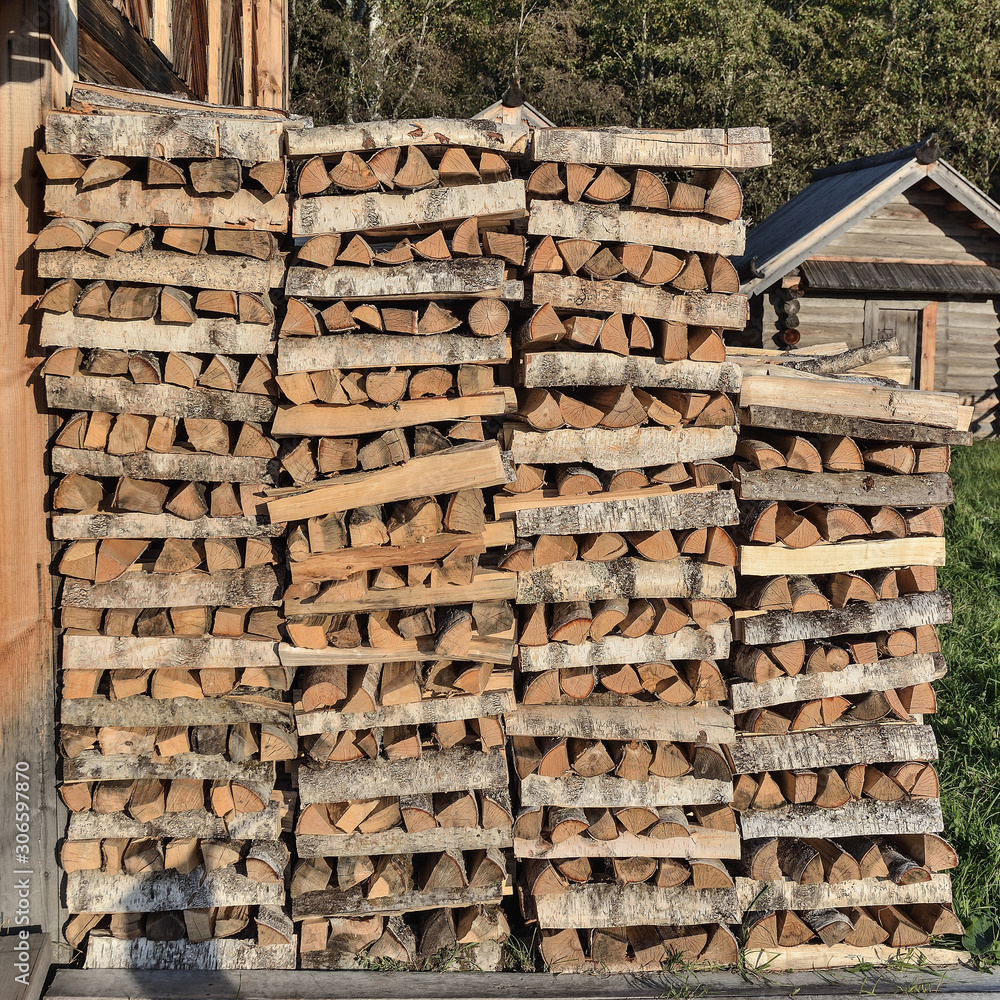 Stack of firewood at the wall of the house Stack of firewood at the wall of the house