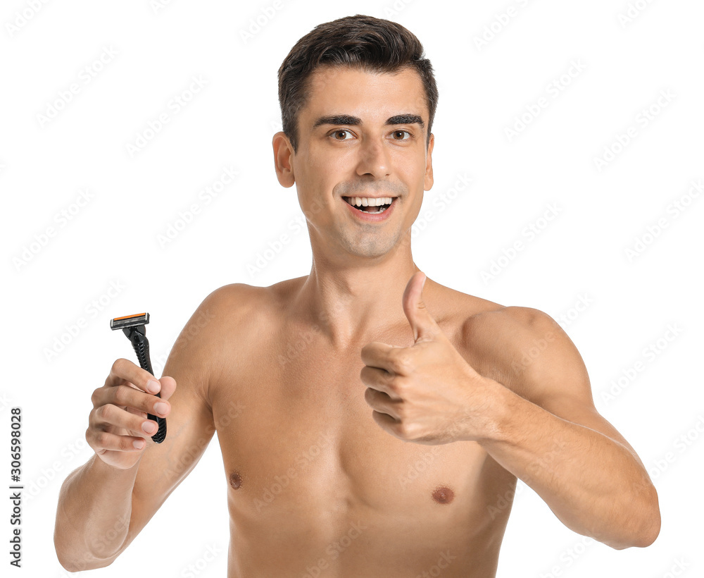 Fototapeta premium Handsome young man with razor showing thumb-up on white background