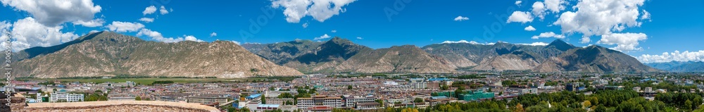 Large panorama of Lhasa, capital of Tibet, China, from the Potala Palace, former residence of the Dalai Lama, with the Himalayas mountains in the background