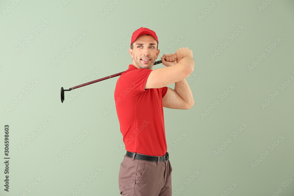 Handsome male golfer on color background