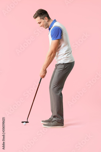 Handsome male golfer on color background © Pixel-Shot