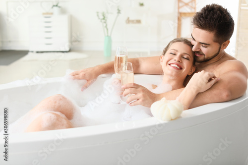 Happy young couple drinking...