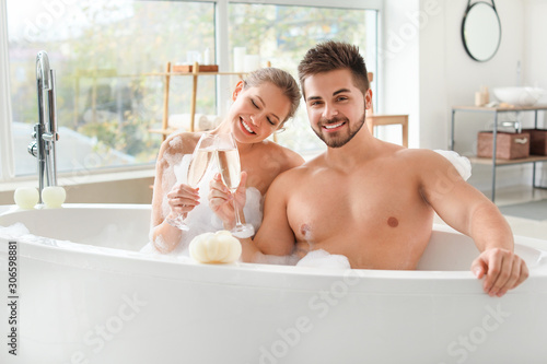 Happy young couple drinking...