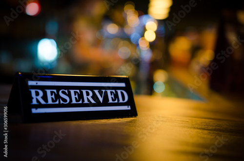 Plastic reserved plate on an arranged restaurant table