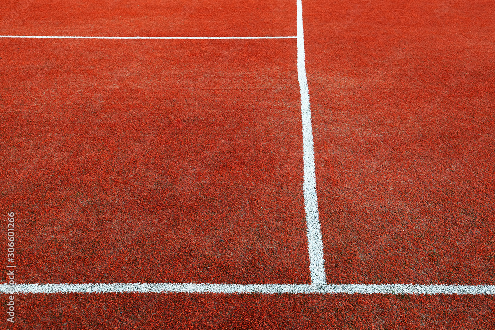 Fototapeta premium Part of empty used red tennis court playground surface with white lines closeup