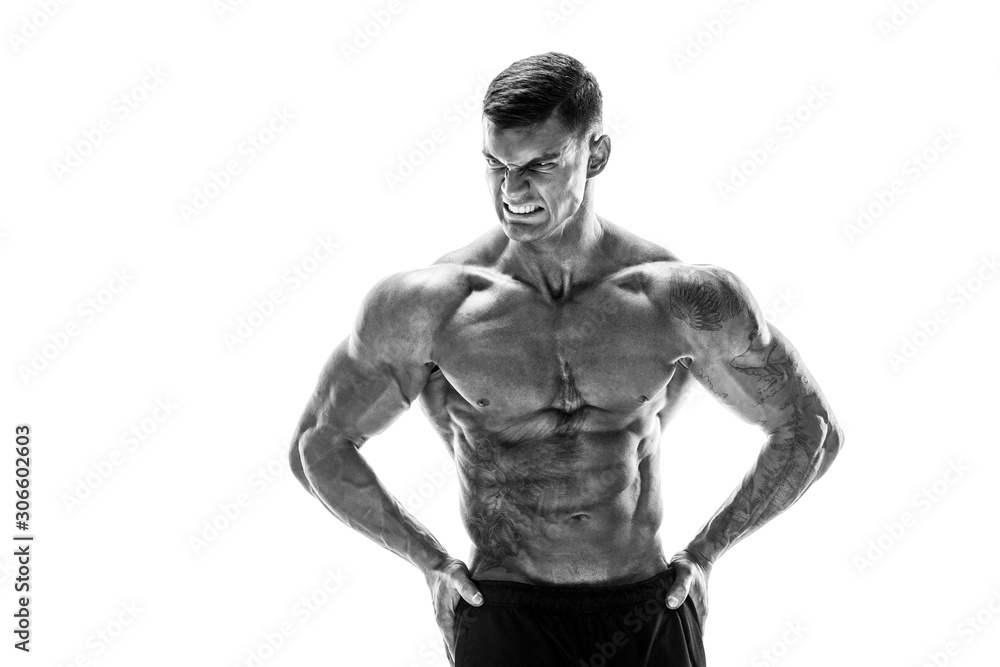 Fototapeta premium Tattooed muscular super-high level handsome man posing in studio isolated on white background