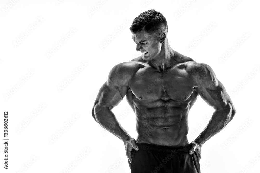 Tattooed muscular super-high level handsome man posing in studio isolated on white background Tattooed muscular super-high level handsome man posing in studio isolated on white background
