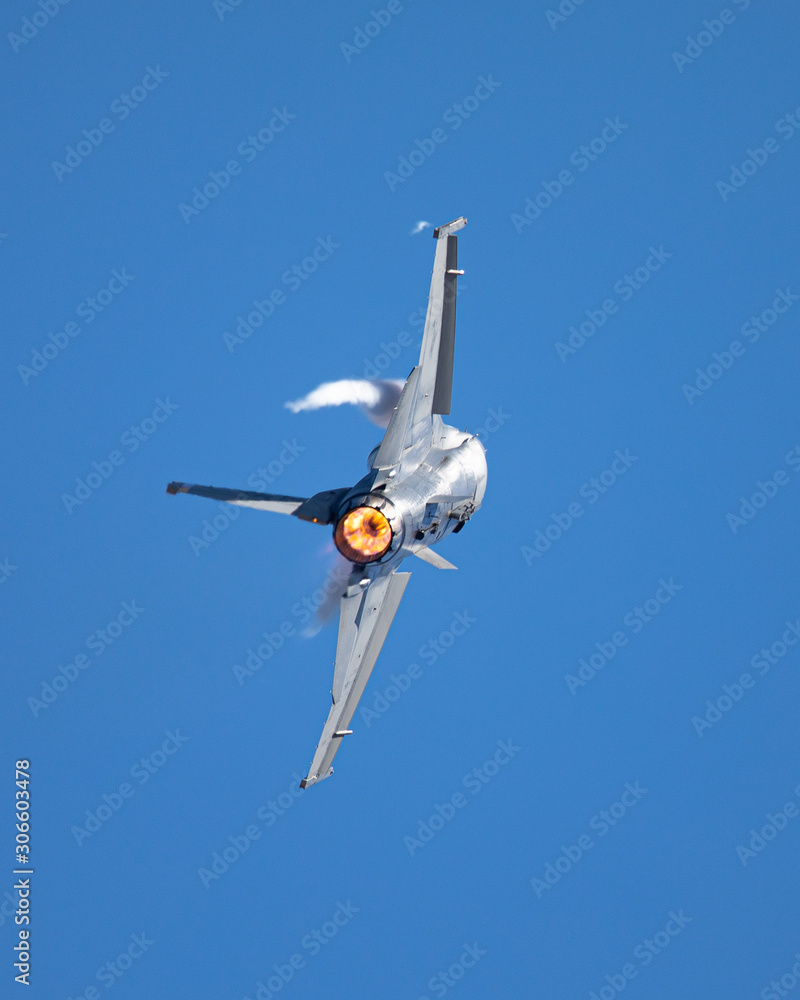 Extremely close view of a F16 Fighting Falcon in a high G turn, with