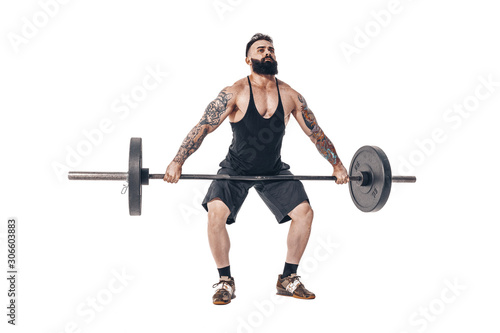 The technique of doing an exercise of deadlift with a barbell of a young muscular strong tattooed bearded sports men on a white studio background. Isolate