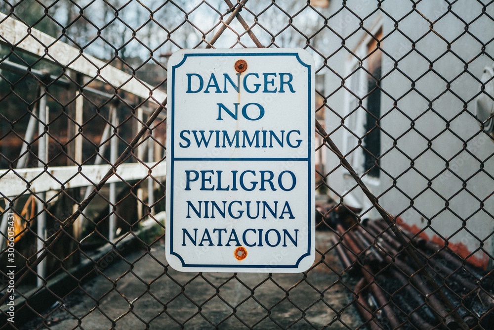 Danger No Swimming Sign on Fence Danger No Swimming Sign on Fence