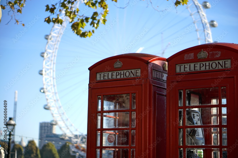 red telephone box in london with london eye in the background red telephone box in london with london eye in the background