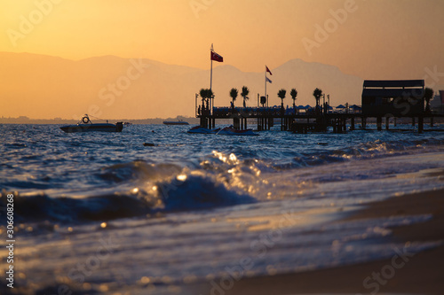 Beautiful golden sunset sea landscape with wooden pier of hotel resort photo