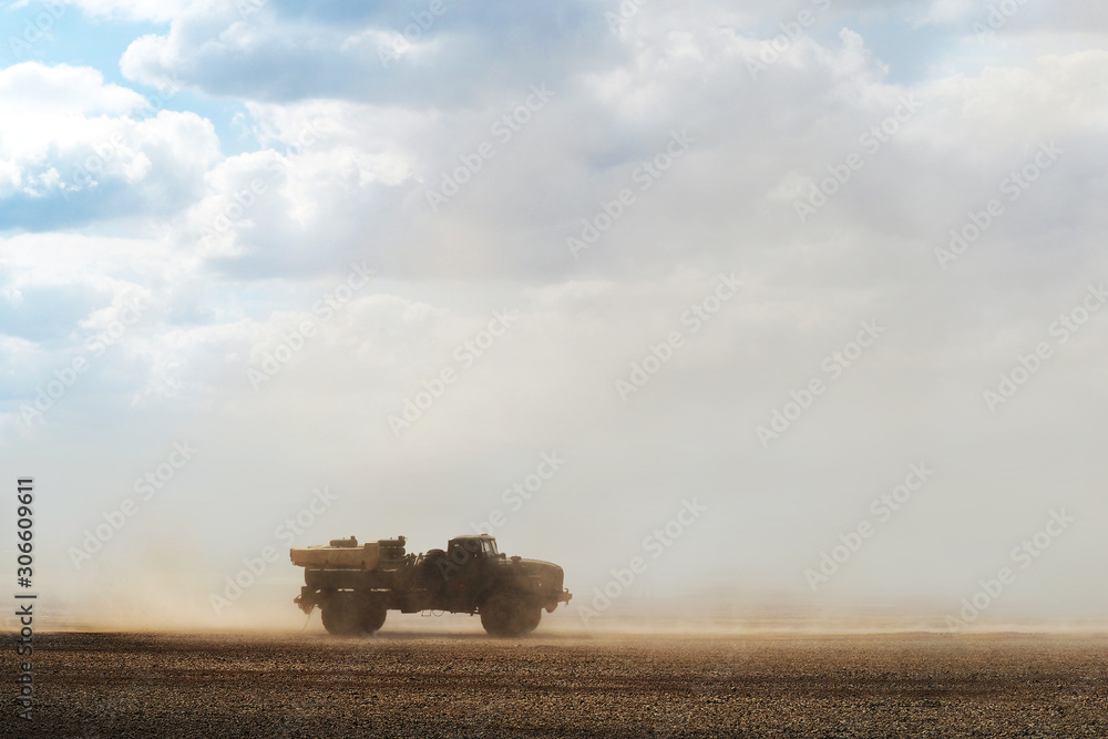 Fototapeta premium Truck in the desert during a dust storm. Desert storm, sandstorm