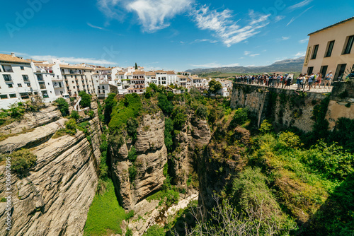 ronda chic mountain view of a fanciful shape covered with greenery, sky, clouds