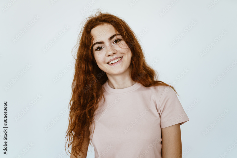 schoolgirl with a smile of joyful admiration looks at the camera, her beautiful teeth are visible, gorgeous hair is disheveled on the shoulders schoolgirl with a smile of joyful admiration looks at the camera, her beautiful teeth are visible, gorgeous hair is disheveled on the shoulders
