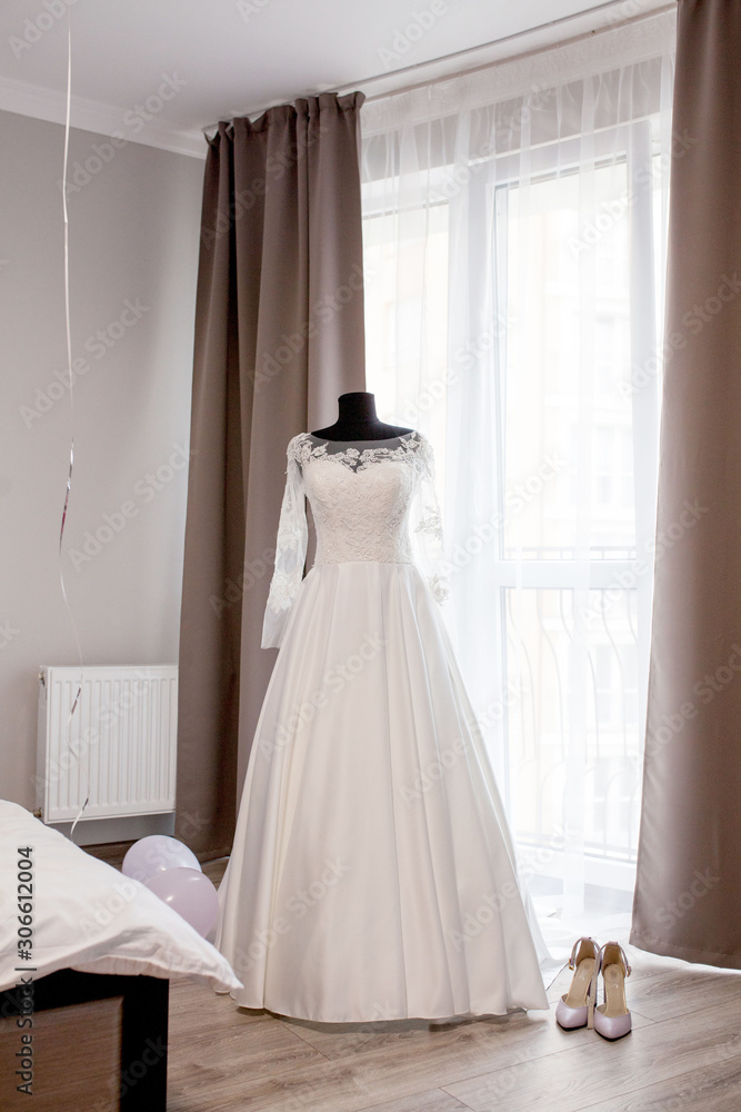 Fototapeta premium Tree wedding dress on a mannequin in room