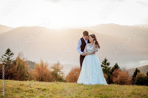 Bride and Groom at Sunset Romantic Married Couple © volody10