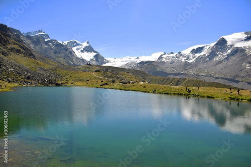 Gorgeous Lake Stellisee with the Swiss Alps and hikers, Zermatt, Switzerland