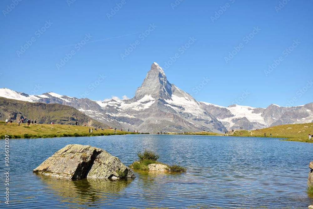 Gorgeous Matterhorn and Stelilisee Lake with clear blue skies (and hikers enjoying the view), Zermatt, Switzerland
