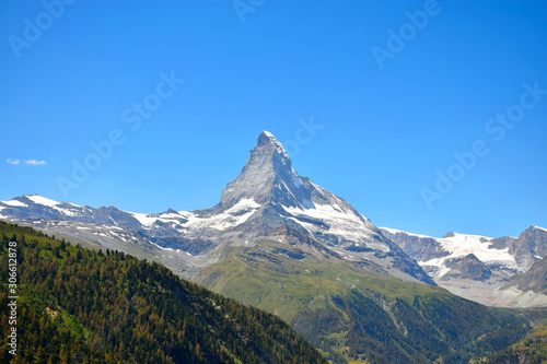 Gorgeous Matterhorn with a green and orange forest and a clear blue sky, Zermatt, Switzerland