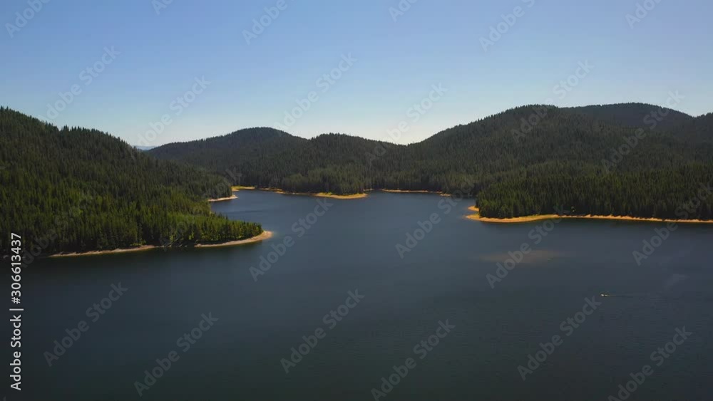 Aerial landscape of beautiful dam surrounded by green forests and magnificent nature high in the mountain Aerial landscape of beautiful dam surrounded by green forests and magnificent nature high in the mountain