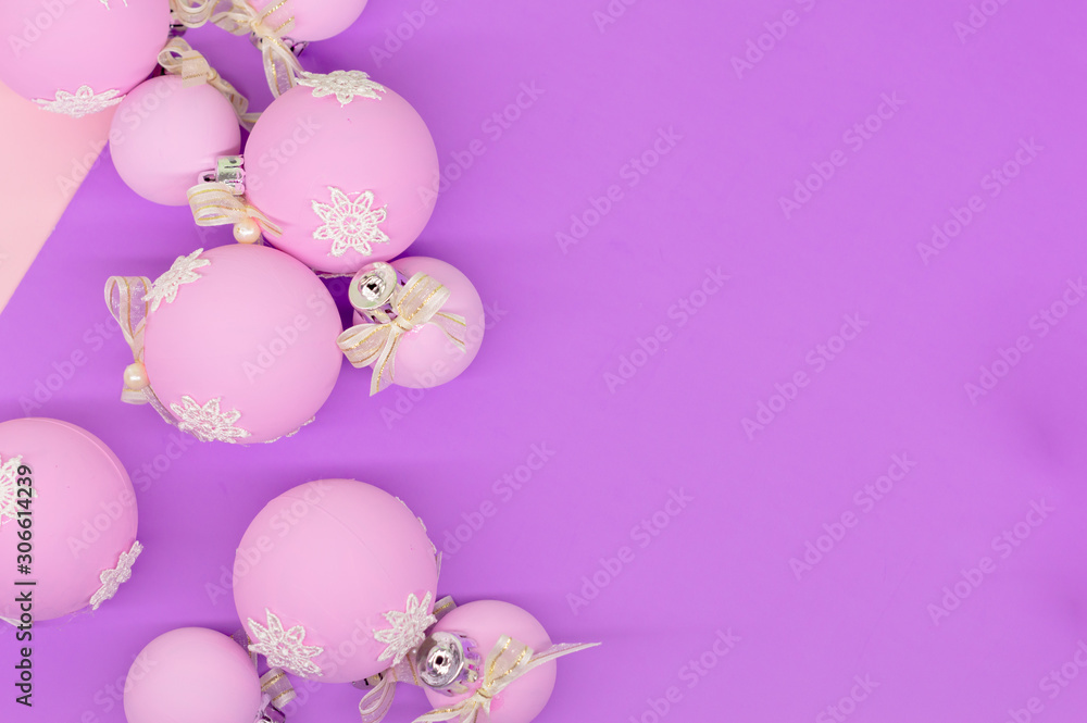Flat lay, Christmas spheres, pink, white and purple background, Xmas and New Year holiday