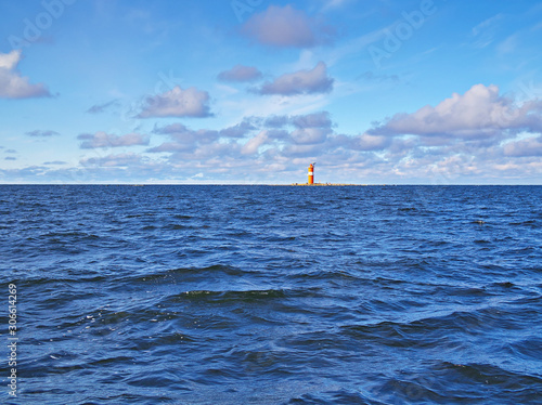 Small orange unmanned lighthouse in the Baltic Sea near Pietarsaari, Finland photo