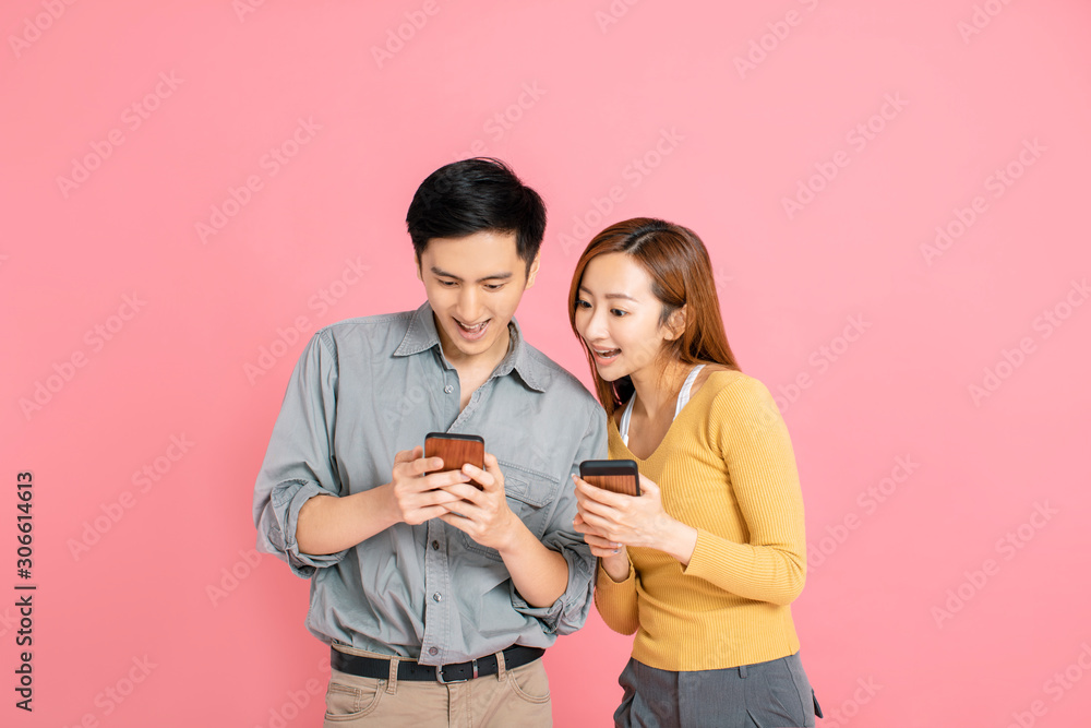 Cheerful young couple watching the smart phone Cheerful young couple watching the smart phone