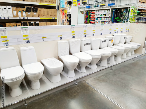 Various toilet bowls are sold in a large building materials store