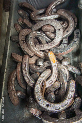 Closeup of old metal horse shoes stacked together