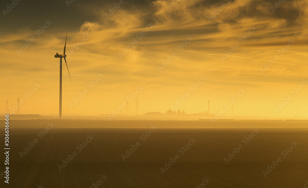 Silhouette of a windmill captured at sunrise , France