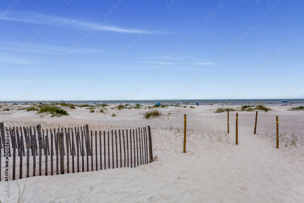 Sand dunes with a wooden fence