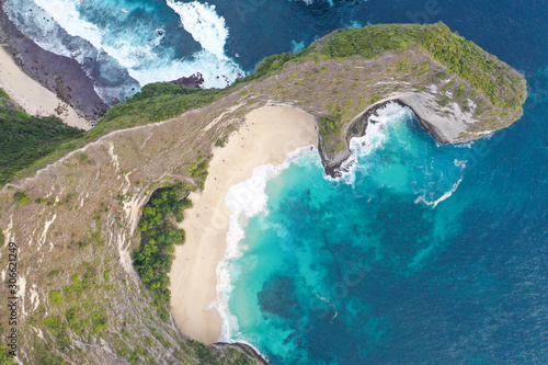 Aerial view of the Kelingking Beach aka Manta Bay with the amazing big wave and blue ocean located in Nusa Penida  Bali  Indonesia.