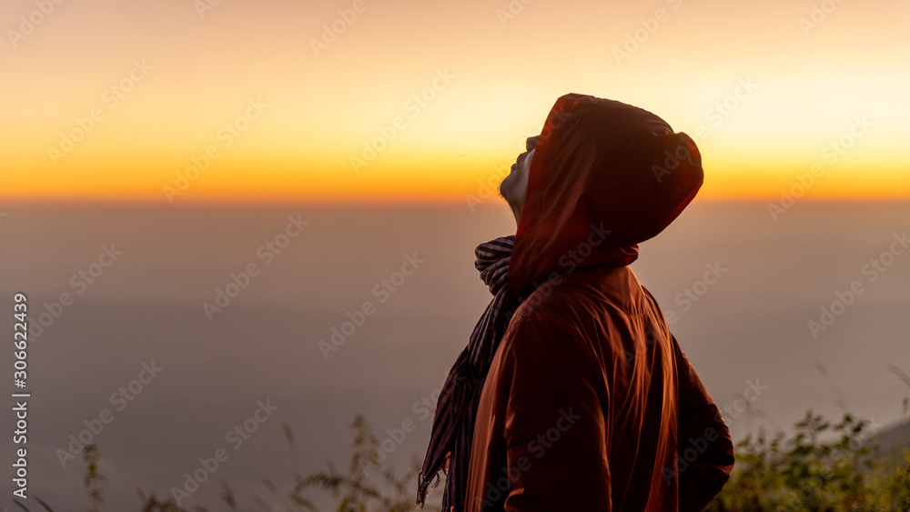 Men wearing sweaters stand to breathe the mountain air. Sunshine Men wearing sweaters stand to breathe the mountain air. Sunshine