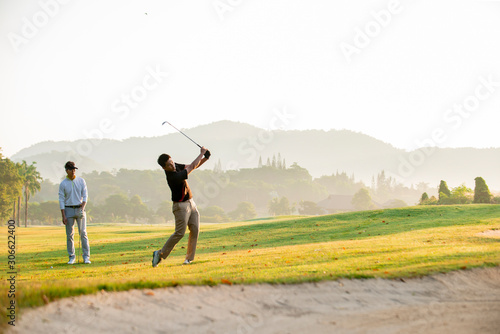  professional  golfer  hit sweeping ball on golf course