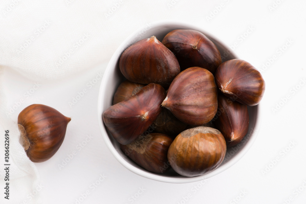Bowl of chestnuts on a white background Bowl of chestnuts on a white background