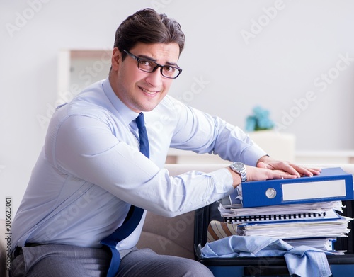 The businessman preparing packing for business trip