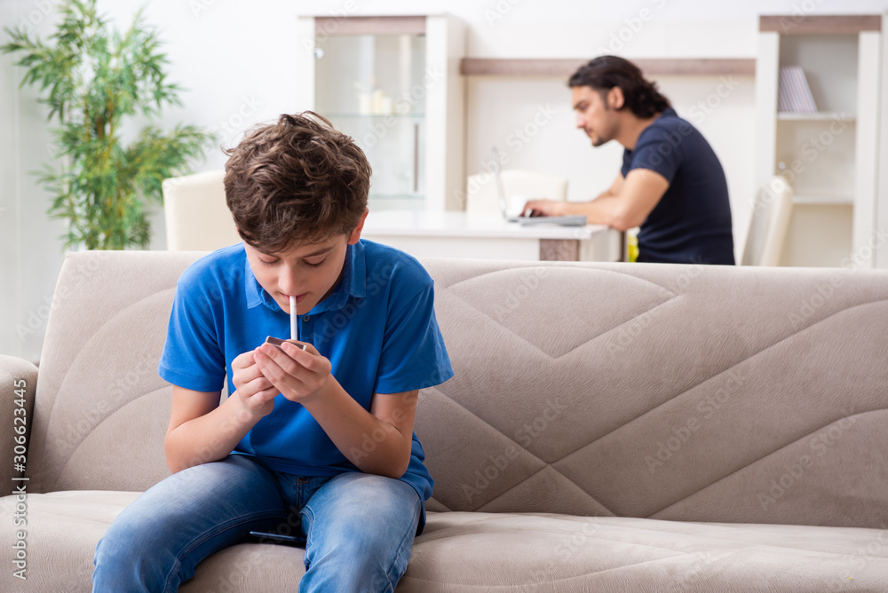 Concept of underage smoking with young boy and family Stock Photo ...