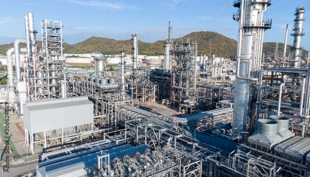 Aerial view of chemical oil refinery plant, power plant on blue sky background. Aerial view of chemical oil refinery plant, power plant on blue sky background.