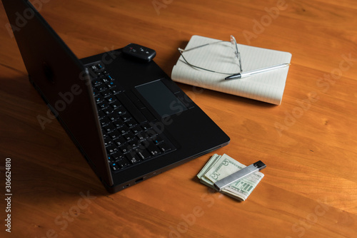 e-cigarette, office desk with black laptop, shallow depth of field