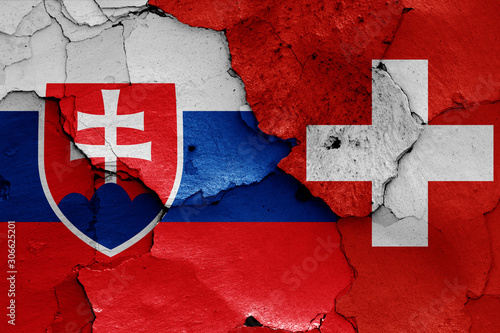 flags of Slovakia and Switzerland painted on cracked wall