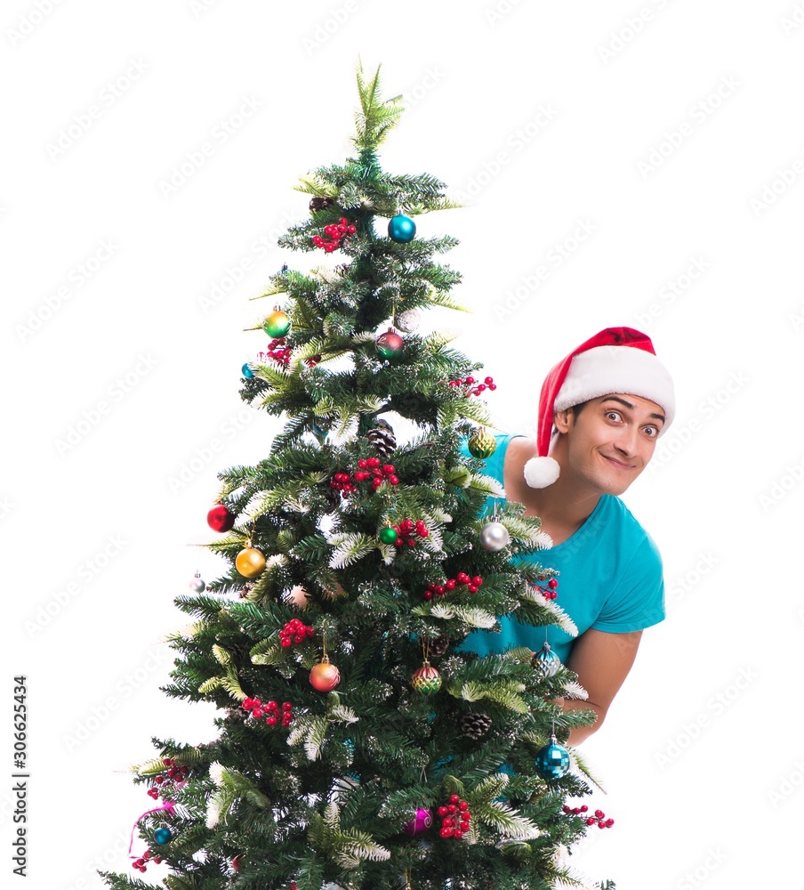 Young man decorating christmas tree isolated on white