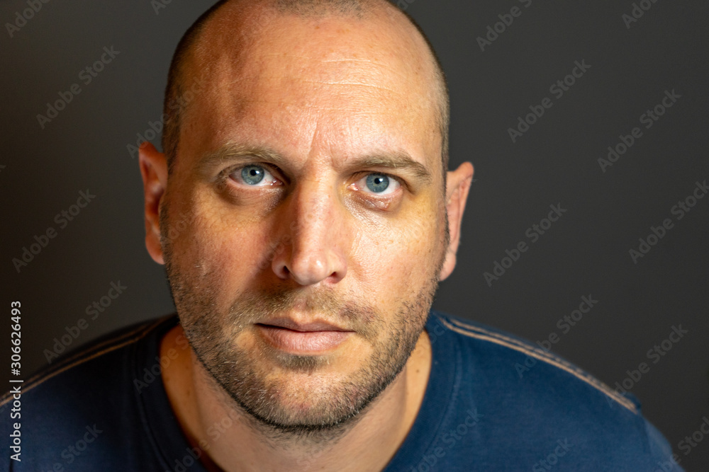 portrait of bald man with blue eyes portrait of bald man with blue eyes